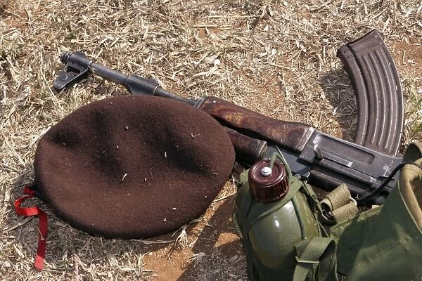 A rifle, military cover and canteen of a Mozambican soldier