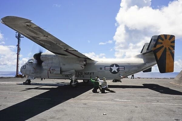 Shooters give the signal to launch a C-2A Greyhound aboard USS George Washington