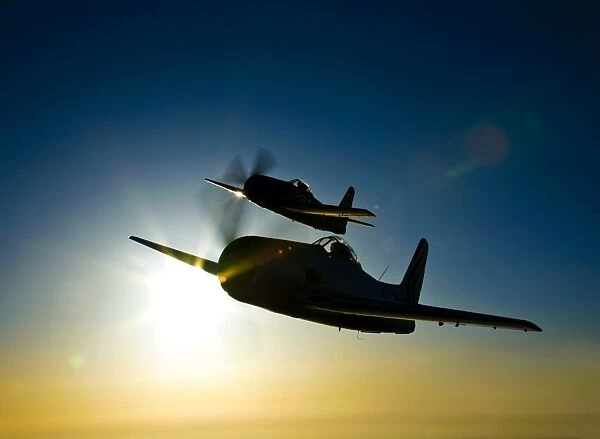 Silhouette of two Grumman F8F Bearcats in flight