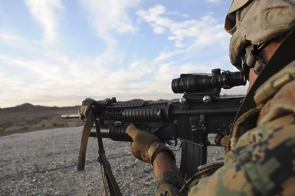 A soldier sights in to fire on a target on a shooting range