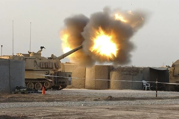 Soldiers fire the howitzers on their M109A6 Paladins