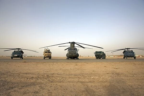 U. S. military vehicles and aircraft lined up on the taxiway at Camp Speicher, Iraq