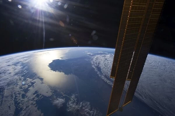 View from space of a setting Sun above part of southwestern Australia