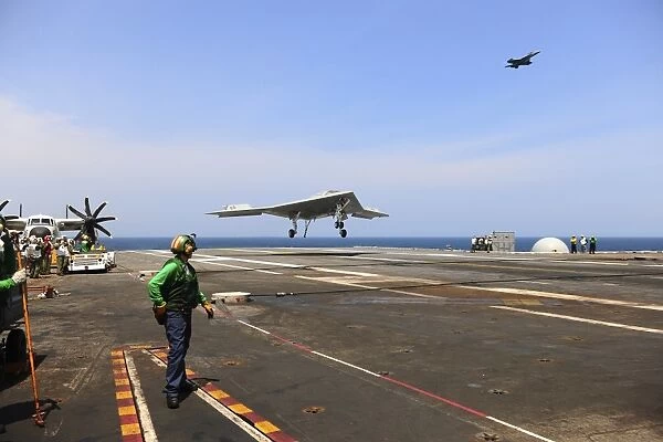 An X-47B Unmanned Combat Air System makes an arrested landing