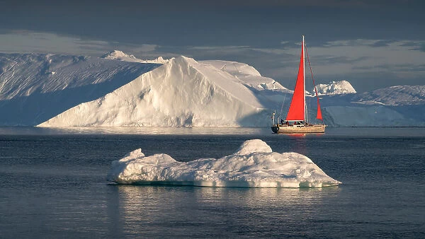 Sailboat between icebergs