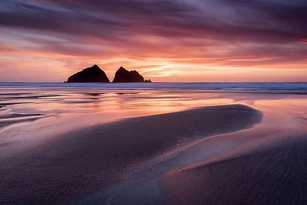 Holywell Bay, low tide at sunset, Carters Rocks and reflections, near Newquay, Cornwall, UK. April 2017