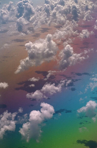 Looking down onf Clouds over Atlantic Ocean with rainbow colours