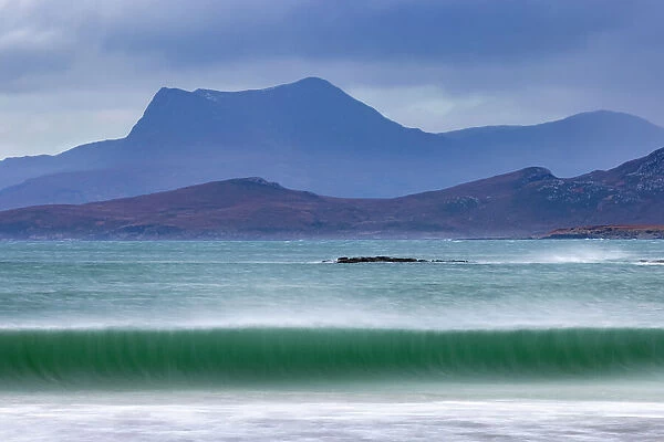 Waves breaking on the beach at Mellon Udrigle, with Beinn Ghobhlach mountain in background, Wester Ross, Scotland, UK. January, 2022