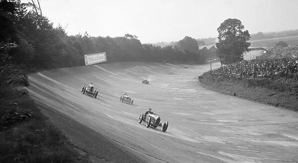 Bugatti Type 54 leading a Talbot 90 on the banking at Brooklands, 1930s. Artist: Bill Brunell