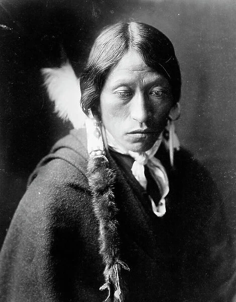 Jicarilla man, head-and-shoulders portrait, facing slightly right, with fur wrapped braids... c1905 Creator: Edward Sheriff Curtis
