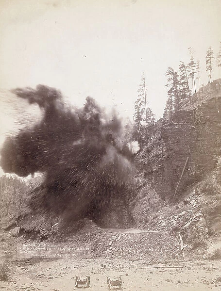 In mid air A wonderful blast in building railroad to Deadwood, 1890. Creator: John C. H. Grabill