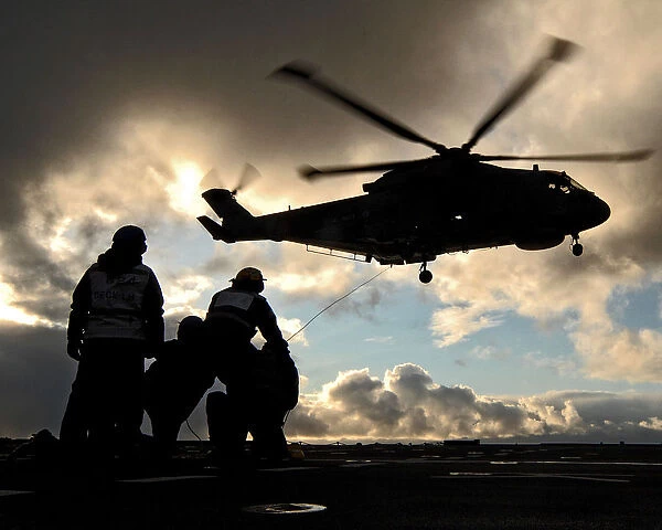 A Merlin of 824 Naval Air Squadron carrying out a high-line transfer