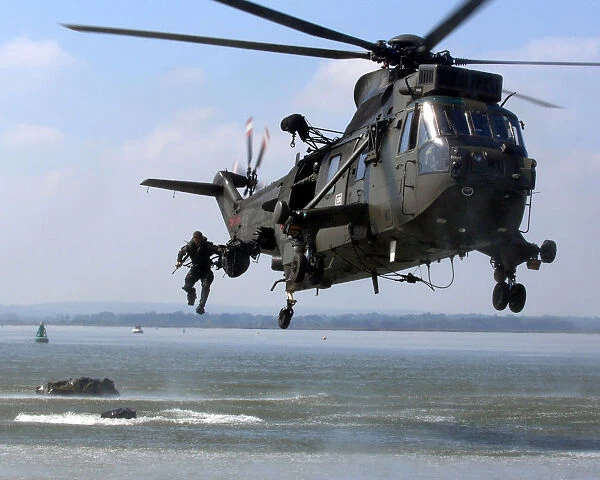 Royal Marine jumps into the sea from Sea King helicopter