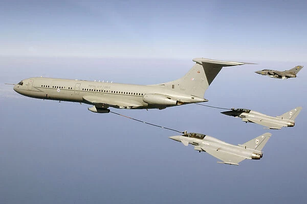 Two Typhoon fighters refuel in mid air with a VC 10 aircraft