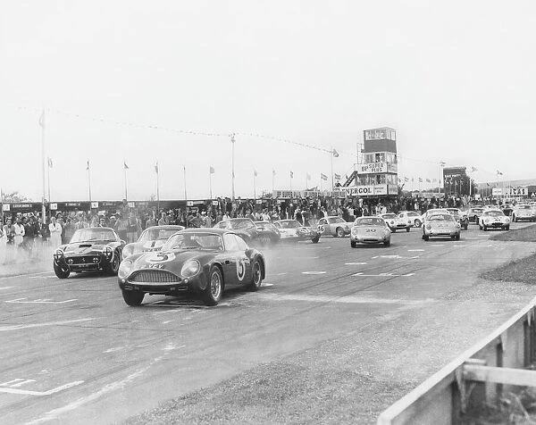 1961 RAC Tourist Trophy: Jim Clark, 4th position, leads Stirling Moss, 1st position, at the strart of the 109 lap race, action