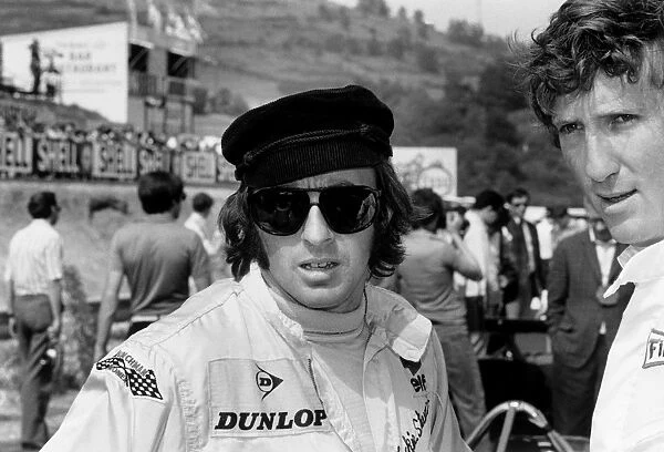 1969 French Grand Prix: Jochen Rindt, 1st position, chats to Jackie Stewart, in the pits, portrait