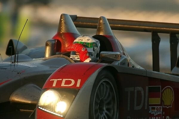 A. McNish(GBR) shields his eyes from the sunrise as he blasts under the dunlop Bridge