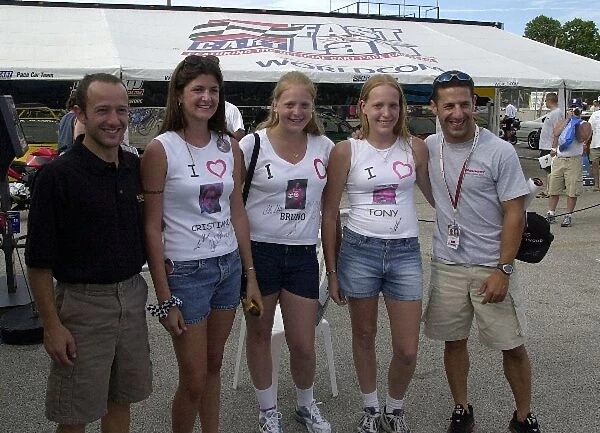 Cristiano da Matta and Tony Kanaan pose with some of their fans at the Motorola 220 at Road America