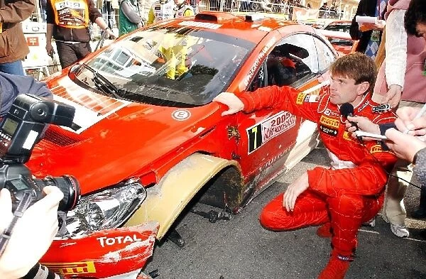FIA World Rally Championship: Marcus Gronholm looks at the damage to his Peugeot 307 WRC at the in control for service