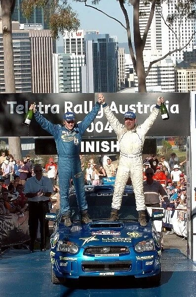 FIA World Rally Championship: Michael Orr and Niall McShea Subaru Impreza WRX celebrate their victory in the Production Cup on the podium