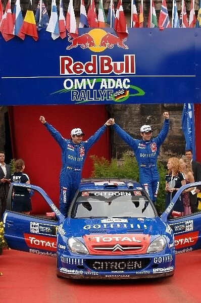 FIA World Rally Championship: R-Sebastien Loeb and L-Daniel Elena celebrate victory on the podium in Trier