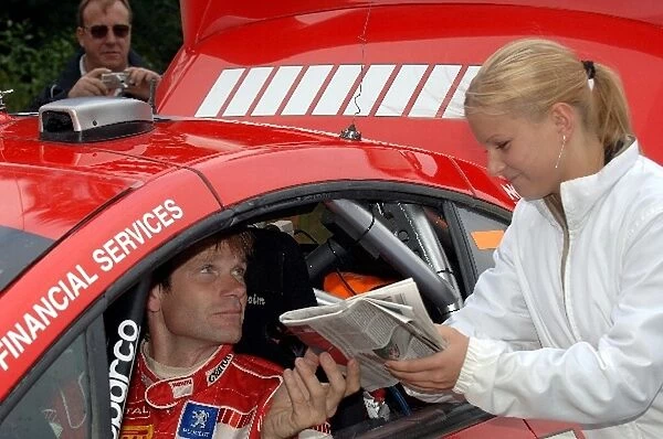 FIA World Rally Championship: Rally winner Marcus Gronholm, Peugeot 307 WRC, signs an autograph for a fan