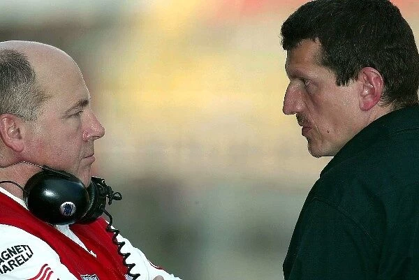 Formula One Testing: Guenther Steiner, right, Jaguar Technical Director chats with a Toyota engineer