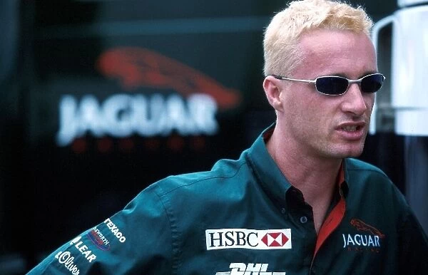 Formula One World Championship: Eddie Irvine Jaguar Cosworth R1 shows off his blonde hair