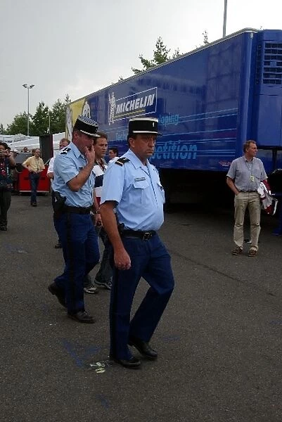 Formula One World Championship: French police leave the paddock after assisting during the impounding of the BAR cars and trucks