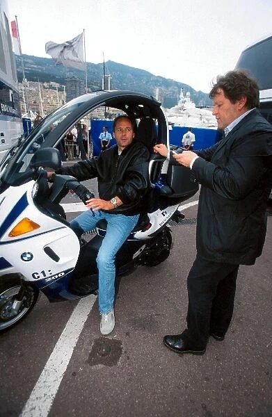 Formula One World Championship: Gerhard Berger BMW Competitions Director aboard a BMW C1: 200 moped talks with Norbert Haug Mercedes Motorsport