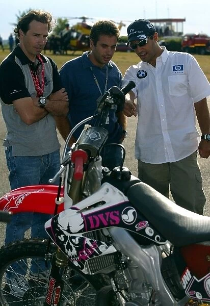 Formula One World Championship: Gonzo and Juan Pablo Montoya Williams take an interest in the motocross bikes at an Alpine Stars event