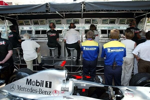 Formula One World Championship: The McLaren team watch qualifying