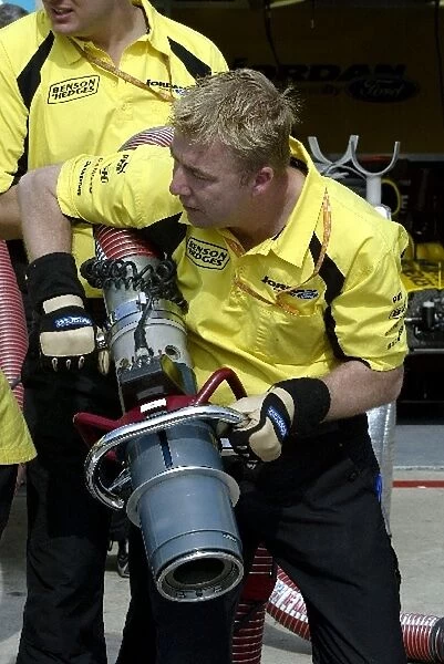 Formula One World Championship: Mick Gomme Jordan mechanic practices refuelling