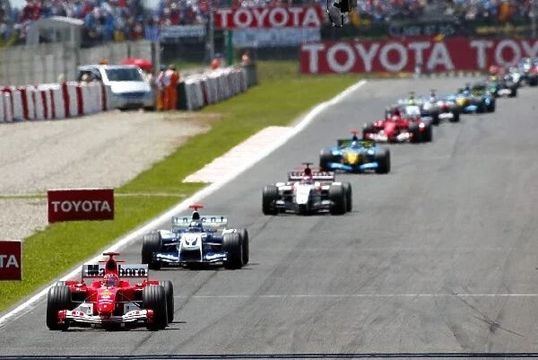 Formula One World Championship: Pole sitter Michael Schumacher Ferrari F2004 on the formation lap