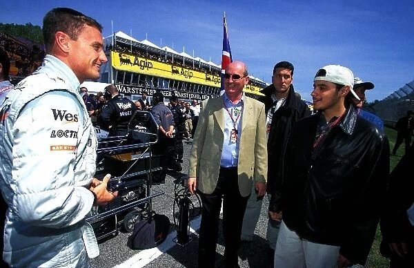 Formula One World Championship: Saudi Prince, Khaled Al Waleed, right, and his representative Brendan McGuiness, centre, meet David Coulthard