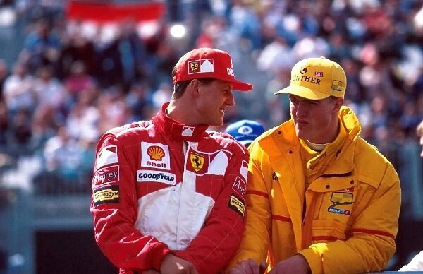Formula One World Championship: Winner Michael Schumacher, Ferrari F310B with brother Ralf Schumacher, Jordan 197, 6th place