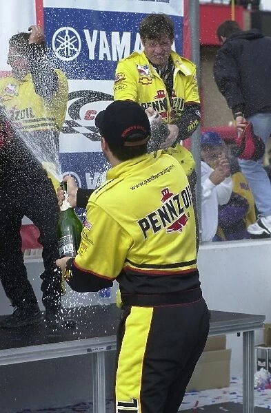 Race winner Sam Hornish, (USA), has a champagne battle with his crew after winning the Yamaha 400
