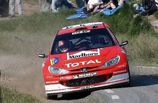 World Rally Championship: Richard Burns with co-driver Robert Reid Peugeot 206 WRC rides on the sumpshield as he cuts a corner on Stage 15
