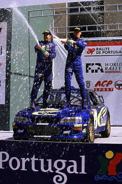 WRC-Richard Burns and Robert Reid celebrating win for Subaru