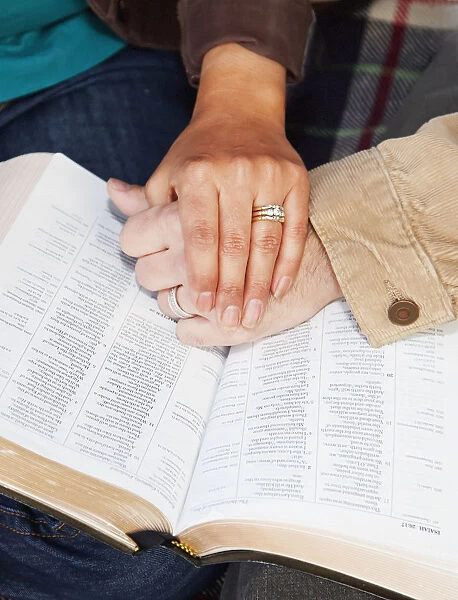 Couples hands on top of a bible; Edmonton alberta canada