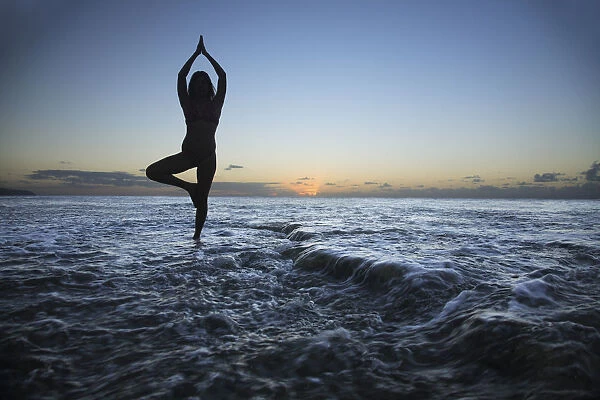 Hawaii, Oahu, Fit Young Girl On The Beach Doing Yoga On The Rocky Coastline