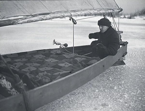 Iceboating in Canada circa 1900. A boat on the ice with a man steering; Canada