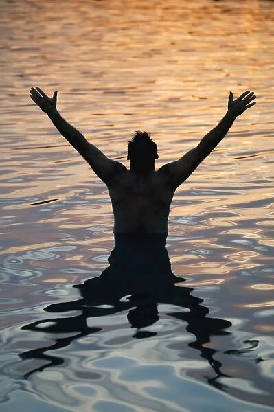 Man With Arms Raised In Water