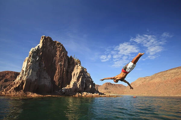 A Man Dives Into The Water Off Espiritu Santos Island Near La Paz; Baja California Mexico