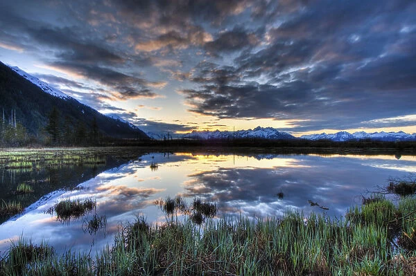 Morning Sky Reflecting On A Pond Near The Copper River Highway Outside Of Cordova, Southcentral Alaska, Spring. Hdr