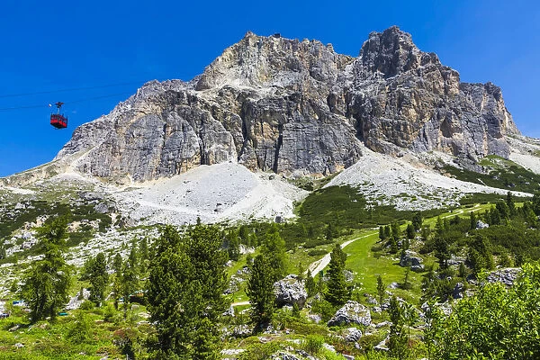 Mountain side view of the Falzarego Pass with an aerial cable car in the Dolomites in the Province of Belluno, Italy