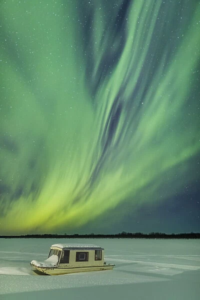 Northern Lights above the snowy shores of Yukon River in Interior Alaska, USA