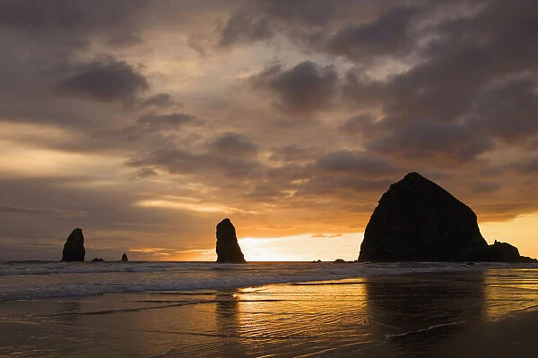 Silhouette Of Rock Formations And Haystack Rock At Sunset; Cannon Beach, Oregon, United States of America