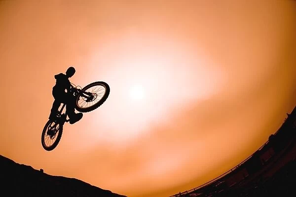Silhouette Of Stunt Cyclist