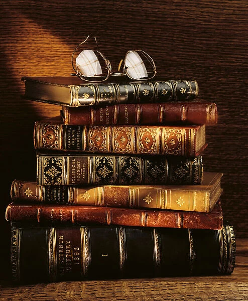 Stack of Antique Books and Eyeglasses For sale as Framed Prints